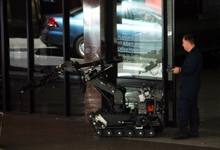 Illustration for article titled Photos of Robot Cleaning Up After Suicide Bomber: Reality Checks Are Often Disturbing